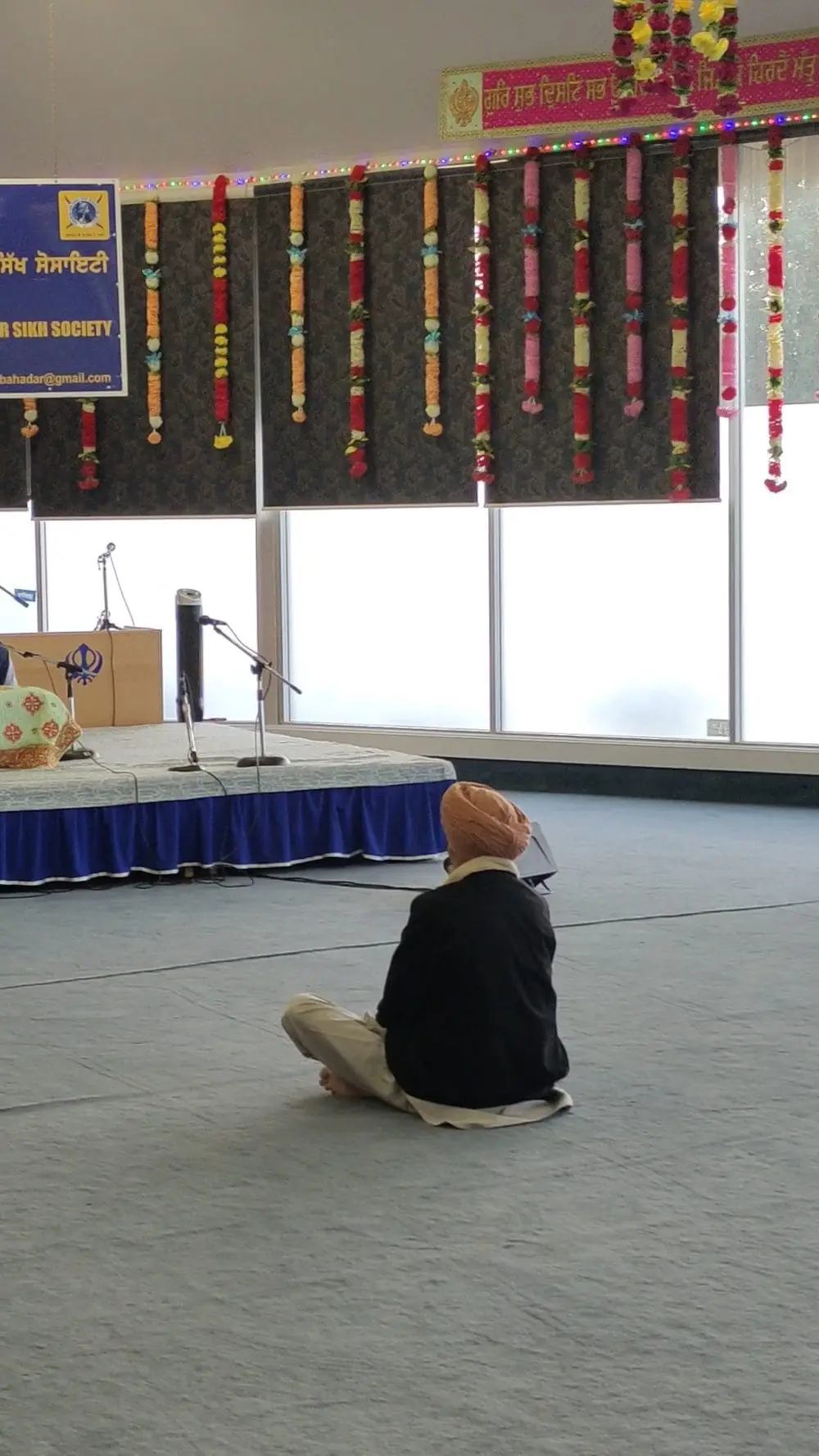 Prayer stage with microphone stands and window light in the background.