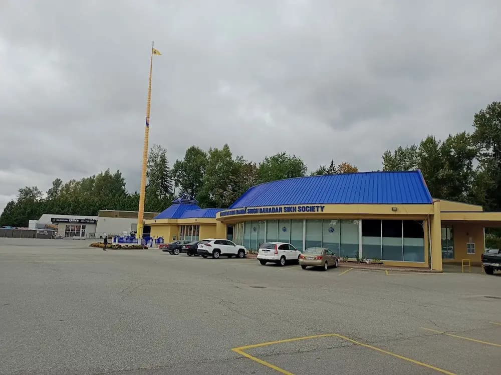 Exterior parking lot and main building under cloudy skies.